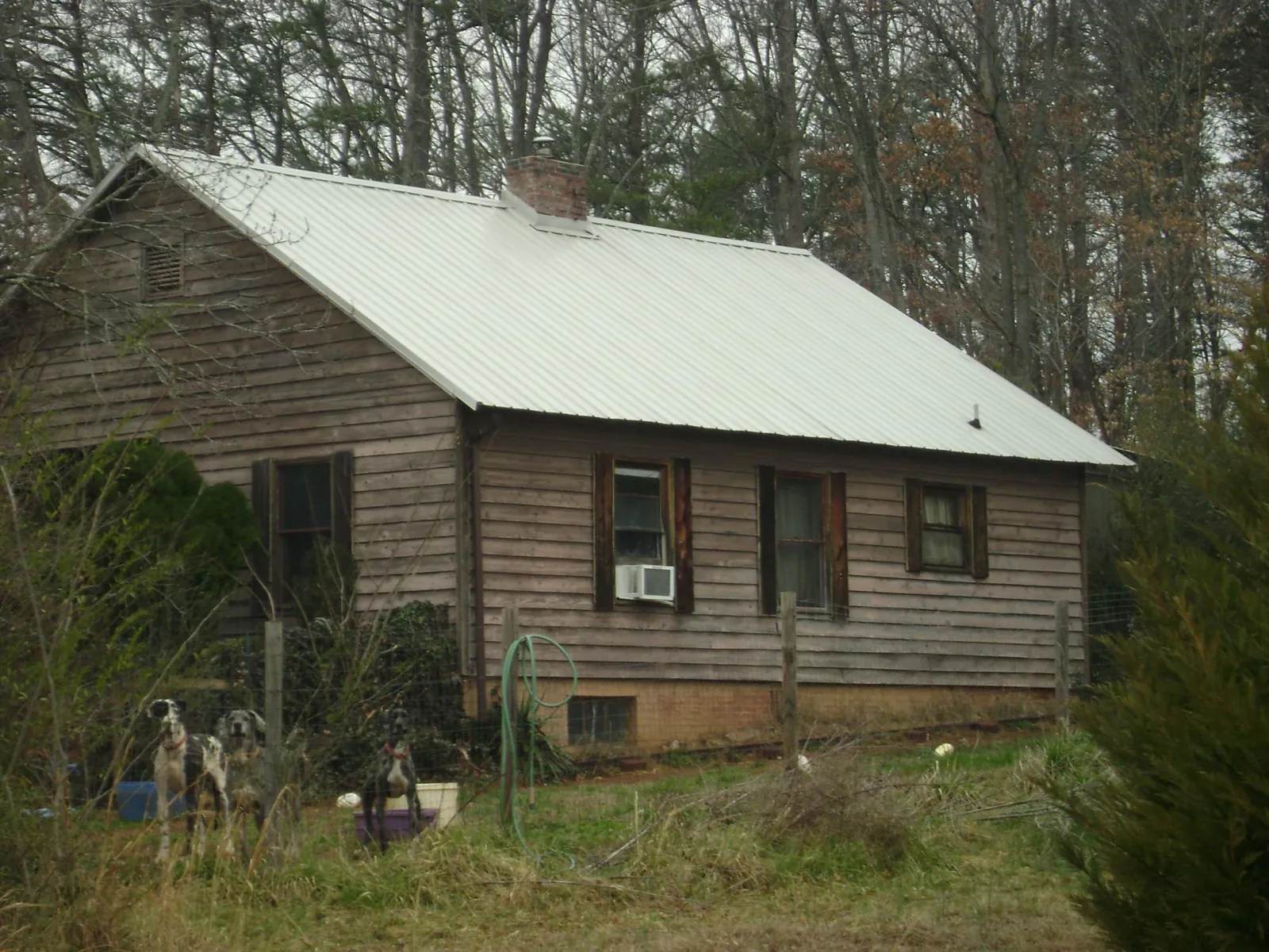White metal roof on an old wood sided farmhouse, from a Metal Roof Installation job in Helendale